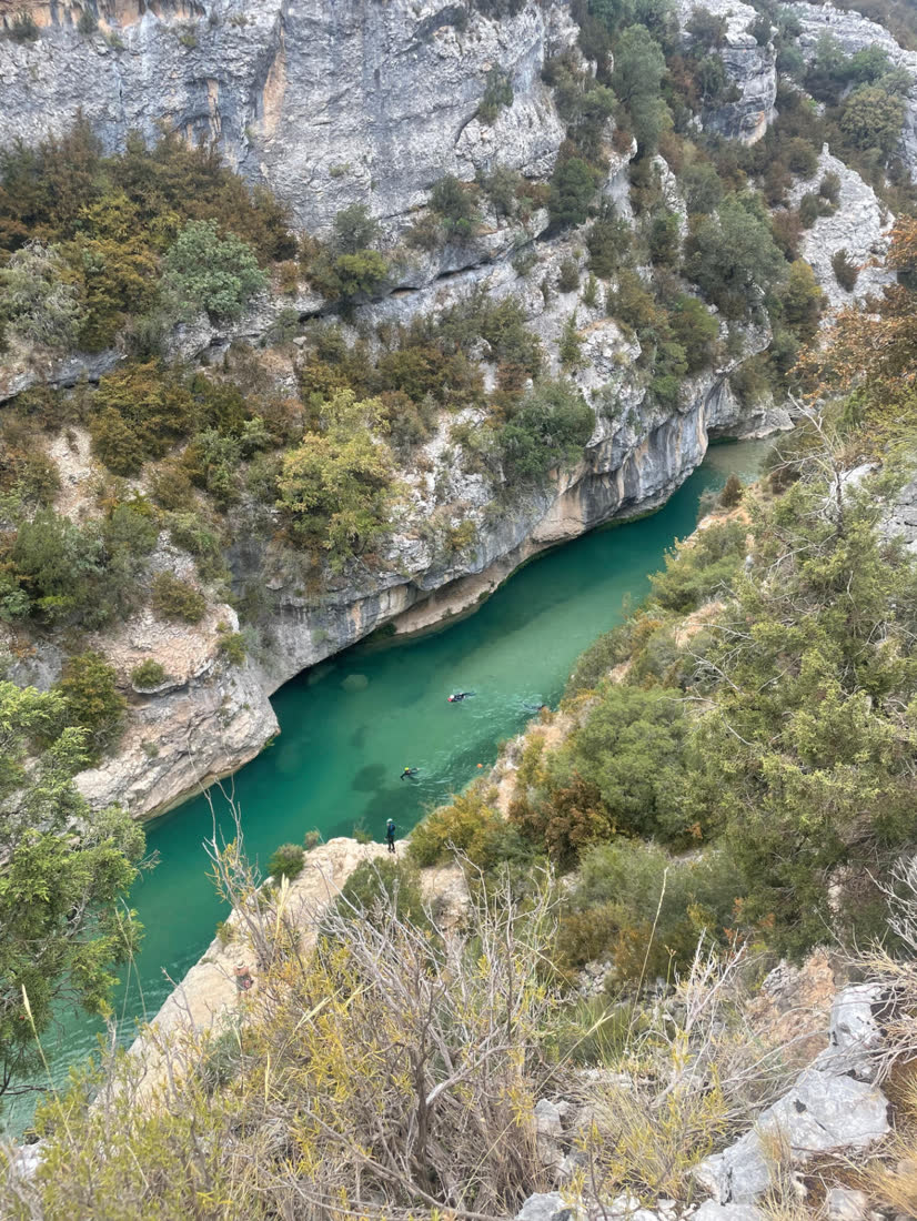 Canyoning group in the emerald waters of the Mascún canyon